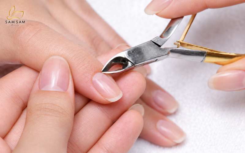 International student at Sam Academy practicing nail techniques on a live model